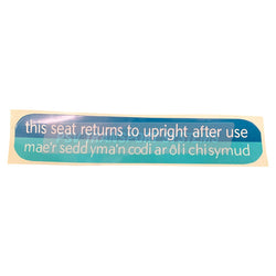 PDP21905-This Seat Returns to Upright After Use Sticker. White English/Welsh Text on Blue Background